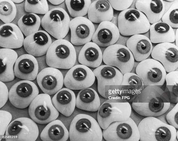 Circa 1940, An assortment of fake plastic eyeballs with rayon veins for realism.