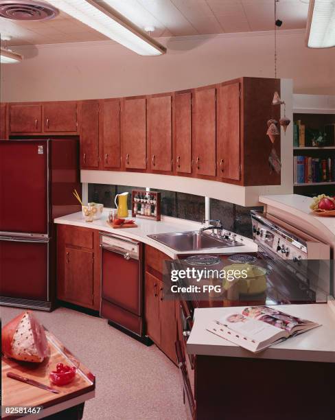 Model kitchen features wood cabinets, a refrigerator, stove, and dishwasher all from General Electric, a sink, plenty of counter space, a soup...