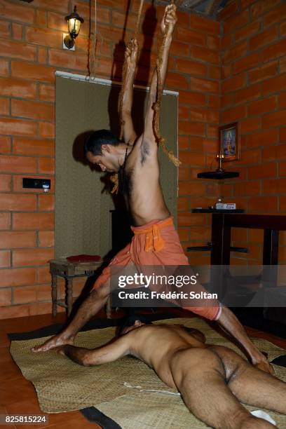 Ayurvedic retreat in Kerala. Massage with hands and feet for a patient following a cure at the Ayurveda Mana treatment centre, during the monsoon...