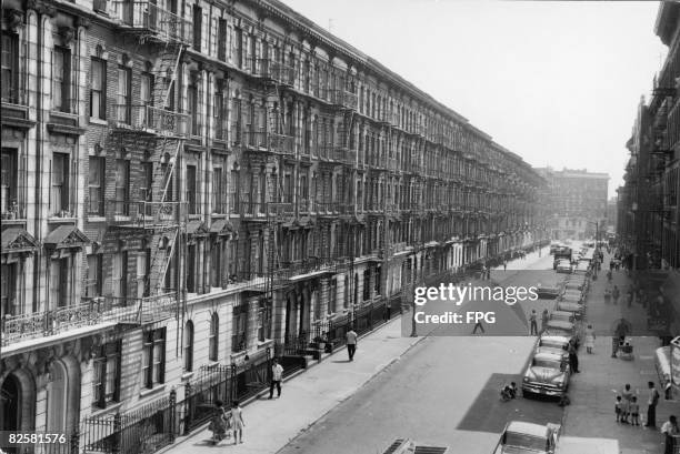 High angle view of a row of apartment buildings along a street in the Bronx, New York, New York, 1950s.