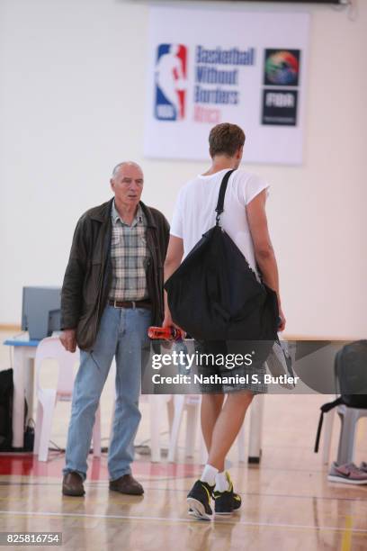 Holger Geschwindner and Dirk Nowitzki of the Dallas Mavericks goes through a workout as part of Basketball Without Borders Africa at the American...