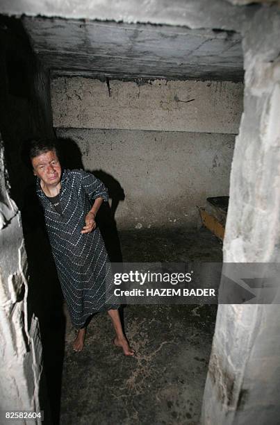 Nawal al-Massalmeh, a 42-year-old mentally disabled Palestinian, stands in a basement room where she and her brother Bassam were kept by their...