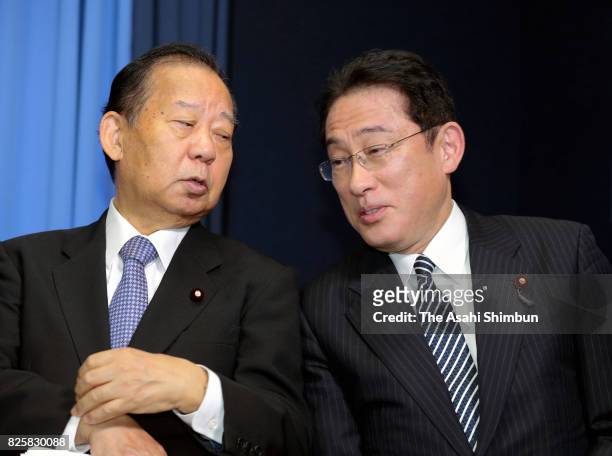 Ruling Liberal Democratic Party new chairman of the Policy Research Council Fumio Kishida and Secretary-General Toshihiro Nikai talk during a press...