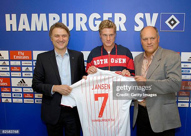 Hamburg's new player Marcell Jansen poses with sport director Dietmar Beiersdorfer and head coach Martin Jol after signing for Hamburger SV at the...