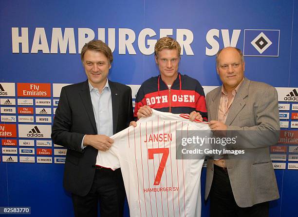 Hamburg's new player Marcell Jansen poses with sport director Dietmar Beiersdorfer and head coach Martin Jol after signing for Hamburger SV at the...