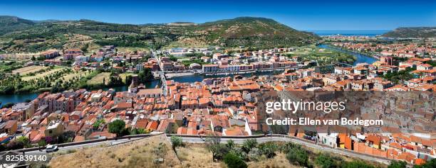 elevated view from medieval castle over the colourful town of bosa along the temo river - oristano stock pictures, royalty-free photos & images