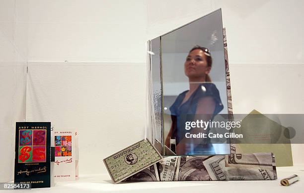 Lady viewing art is reflected in the Limited edition 123/1000 "Snowblind, A Brief Career in the Cocaine Trade" an exhibit made of a book, 100 USD...