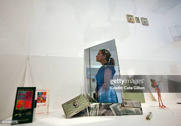 Lady viewing art is reflected in the Limited edition 123/1000 "Snowblind, A Brief Career in the Cocaine Trade" an exhibit made of a book, 100 USD...