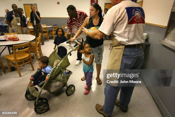 Democratic National Convention delegate serves food to a homeless family at the Denver Rescue Mission shelter August 27, 2008 in Denver, Colorado....