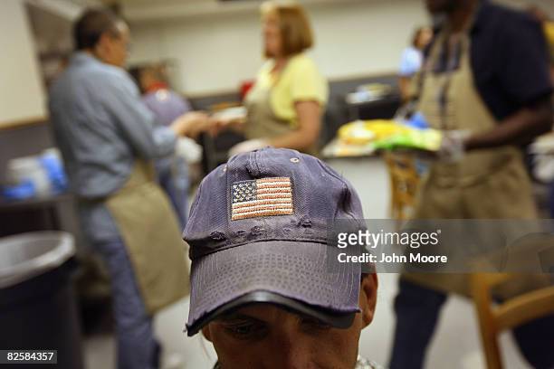 Homeless man sits for a free lunch at the Denver Rescue Mission shelter August 27, 2008 in Denver, Colorado. Some 1,400 delegates to the Democratic...