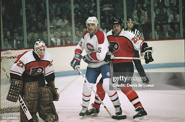 Canadiens forward Bobby Smith jockeys for position against Flyers defenceman Kjell Samuelsson in front of goaltender Ron Hextall at the Montreal...