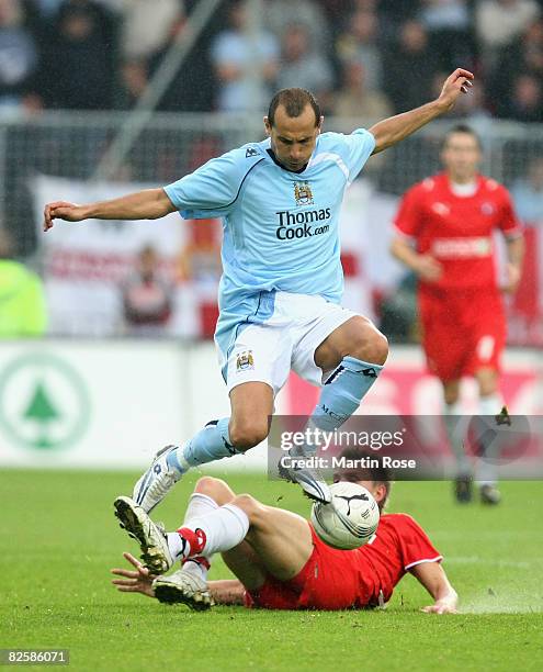 Christopher Poulsen of Midtjylland and Martin Petrov of Manchester compete for the ball during the UEFA Cup second qualifying round, first leg match...