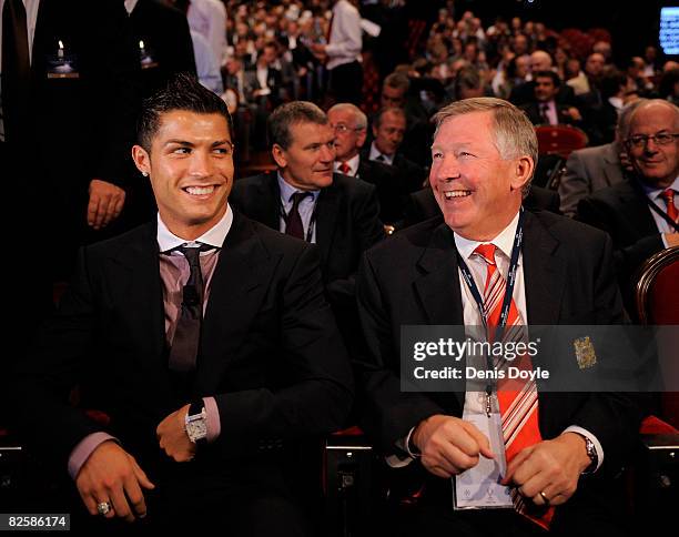 Cristiano Ronaldo of Manchester United laughs with his manager Sir Alex Ferguson while attending the UEFA Champions League Draw for the 2008/2009...