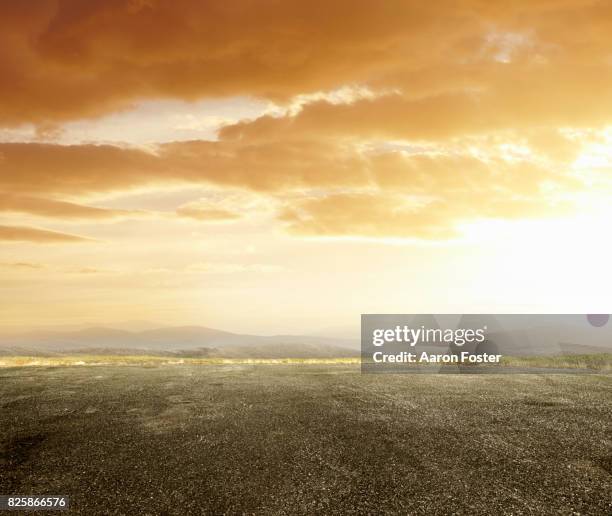 open empty parking lot - golden clouds stockfoto's en -beelden