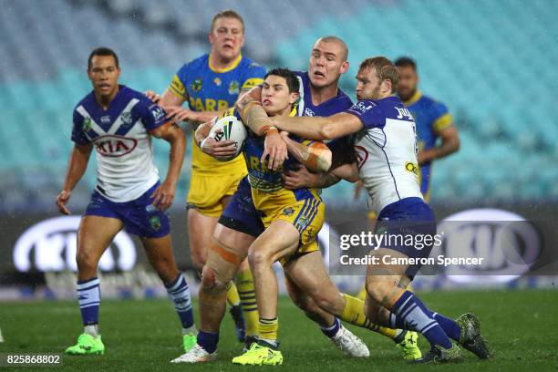 Mitchell Moses of the Eels is tackled during the round 22 NRL match between the Canterbury Bulldogs and the Parramatta Eels at ANZ Stadium on August...