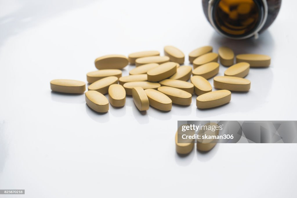 Dietary supplement tablet and Vitamin tablet Medicine (pharmacy) and bottle  on white background