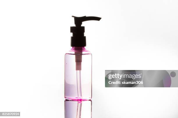 colorful realistic cosmetic bottle on wet and darken background. cosmetic package collection for cream, - shampoo bottle white background stock pictures, royalty-free photos & images