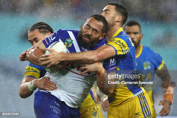 Sam Kasiano of the Bulldogs is tackled during the round 22 NRL match between the Canterbury Bulldogs and the Parramatta Eels at ANZ Stadium on August...