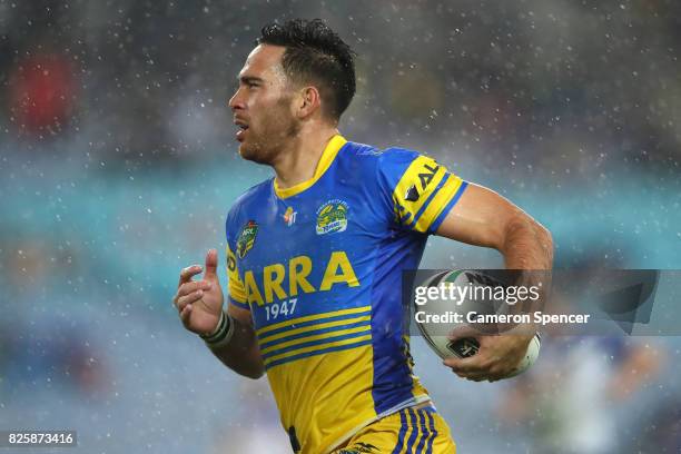 Corey Norman of the Eels runs the ball during the round 22 NRL match between the Canterbury Bulldogs and the Parramatta Eels at ANZ Stadium on August...