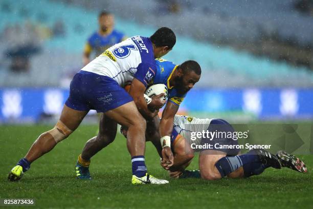 Semi Radradra of the Eels is tackled during the round 22 NRL match between the Canterbury Bulldogs and the Parramatta Eels at ANZ Stadium on August...