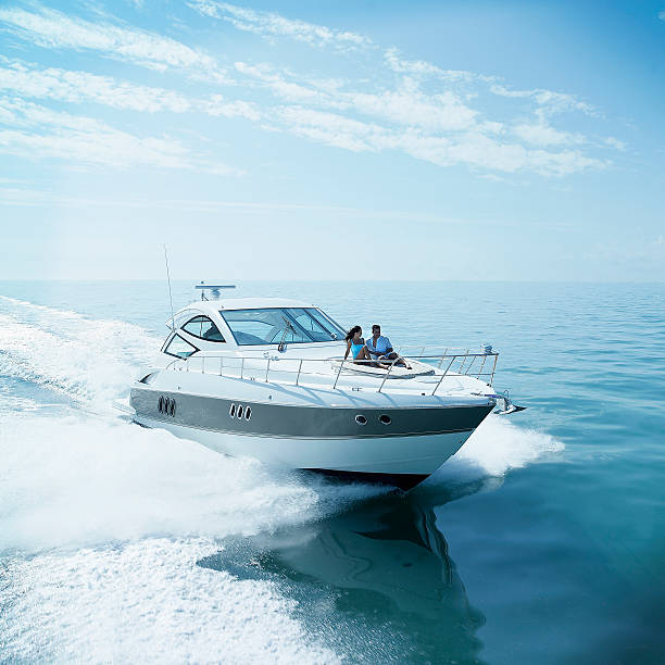 couple on bow of yacht - yacht stock pictures, royalty-free photos & images