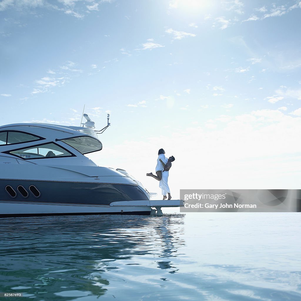 Couple on stern of power boat