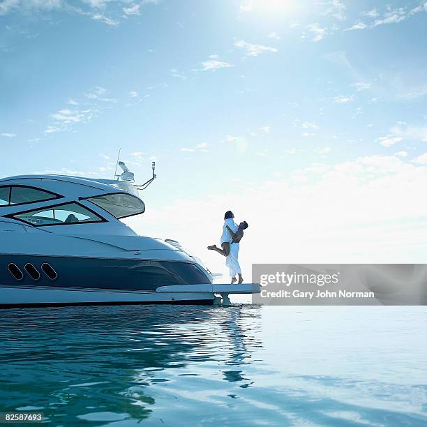 couple on stern of power boat - motorboat foto e immagini stock