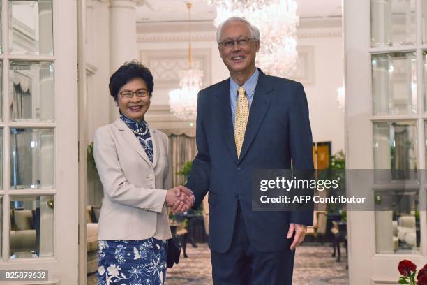 Hong Kong's Chief Executive Carrie Lam shakes hands with Singapore Emeritus Senior Minister Goh Chok Tong during a call at Istana presidential palace...