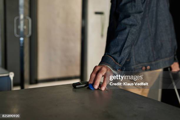 mature couple leaving rental flat, with suitcases and bag - key in door stock-fotos und bilder