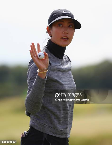 Michelle Wie of the United States celebrates her putt on the 18th green during the first round of the Ricoh Women's British Open at Kingsbarns Golf...