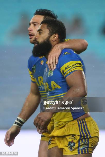 Corey Norman of the Eels embraces team mate Michael Jennings during the round 22 NRL match between the Canterbury Bulldogs and the Parramatta Eels at...