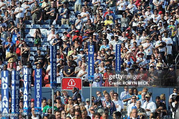 Supporters listen to the National Anthem at the Democratic National Convention 2008 at the Invesco Field in Denver, Colorado, on August 28, 2008....