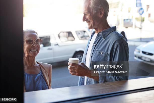 Senior couple ordering coffee to-go, at street bakery