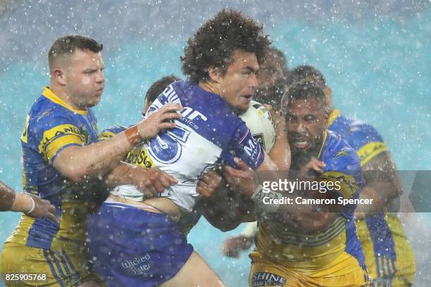 Raymond Faitala of the Bulldogs is tackled during the round 22 NRL match between the Canterbury Bulldogs and the Parramatta Eels at ANZ Stadium on...