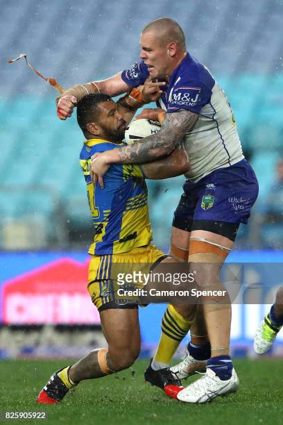 Manu Ma'u of the Eels is tackled by David Klemmer of the Bulldogs during the round 22 NRL match between the Canterbury Bulldogs and the Parramatta...