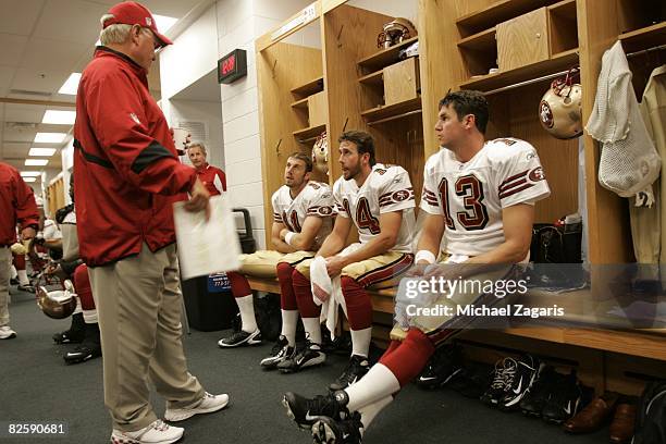 Mike Martz meets with Alex Smith, J.T. O'Sullivan and Shaun Hill of the San Francisco 49ers in the clubhouse before the NFL game against the Chicago...