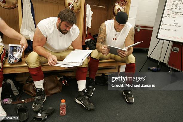 Eric Heitmann and Barry Sims of the San Francisco 49ers review plays in the locker room before the NFL game against the Chicago Bears at Soldier...