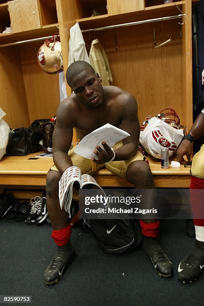 Frank Gore of the San Francisco 49ers reviews plays in the locker room before the NFL game against the Chicago Bears at Soldier Field on August 21,...