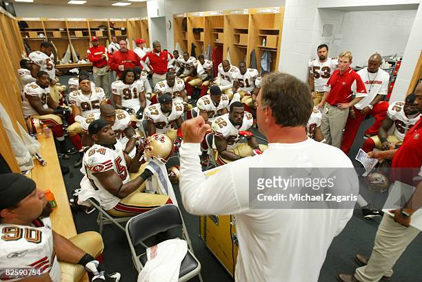 Greg Manusky of the San Francisco 49ers addresses the defensive line in the locker room at halftime during the NFL game against the Chicago Bears at...