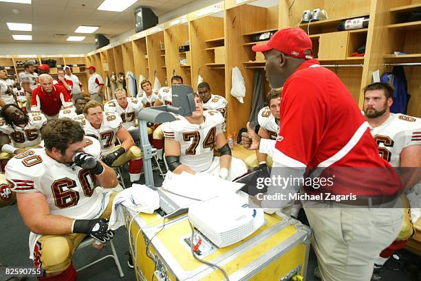 George Warhop of the San Francisco 49ers addresses the offensive line in the locker room at halftime during the NFL game against the Chicago Bears at...