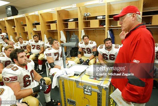 Mike Martz of the San Francisco 49ers addresses the offensive line in the locker room at halftime during the NFL game against the Chicago Bears at...