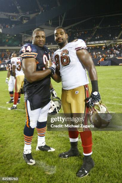 Kentwan Balmer of the San Francisco 49ers with Marcus Harrison of Chicago Bears at Soldier Field after the NFL game on August 21, 2008 in Chicago,...