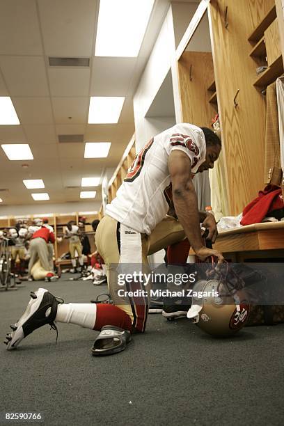 Allen Rossum of the San Francisco 49ers prepares in the locker room before the NFL game against the Chicago Bears at Soldier Field on August 21, 2008...