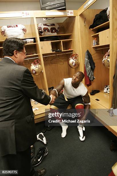 Parys Haralson of the San Francisco 49ers greets Dr. John York in the locker room before the NFL game against the Chicago Bears at Soldier Field on...