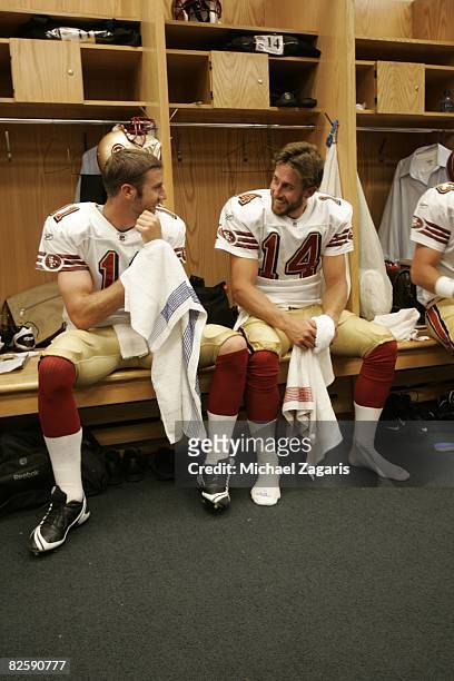 Alex Smith and J.T. O'Sullivan of the San Francisco 49ers talk in the clubhouse before the NFL game against the Chicago Bears at Soldier Field on...