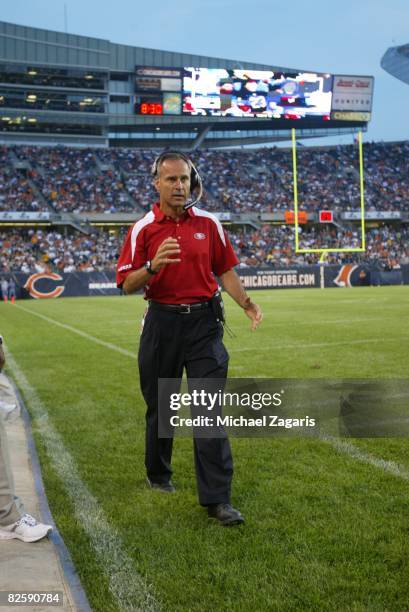 Head Coach Mike Nolan of the San Francisco 49ers makes calls during the NFL game against the Chicago Bears at Soldier Field on August 21, 2008 in...