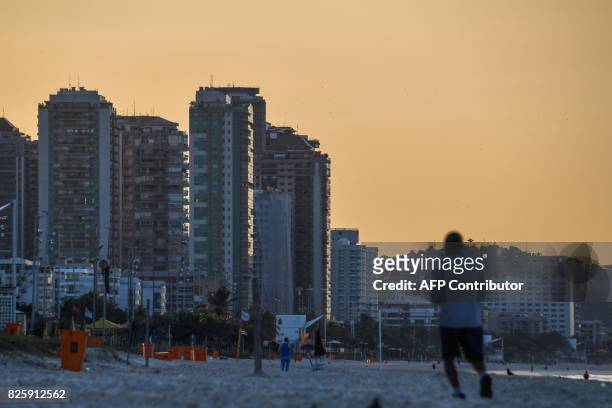Man jogs in the morning along Praia da Barra in Rio de Janeiro on August 3, 2017. Rio de Janeiro almost duplicated its hotel capacity in 2016 for the...