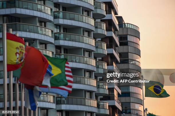 Brazilian and foreigners flags flutter in front of hotels at Praia da Barra in Rio de Janeiro on August 3, 2017. Rio de Janeiro almost duplicated its...