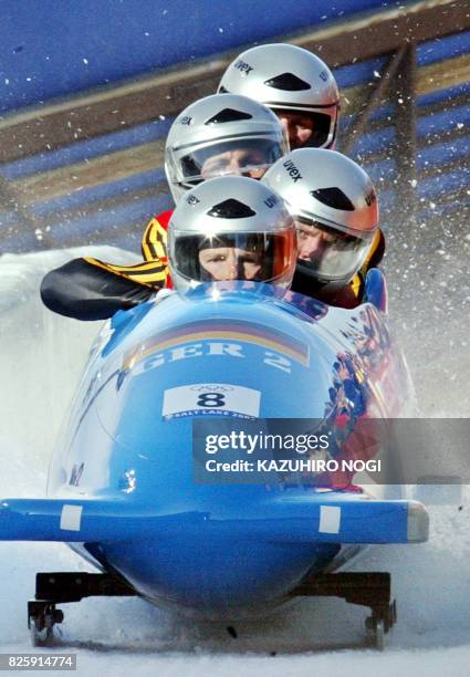 Three-time World championship medallist, German bobsleig pilot Andre Lange and his teammate Enrico Kuehn, Kevin Kuske and Carsten Embach slow down...