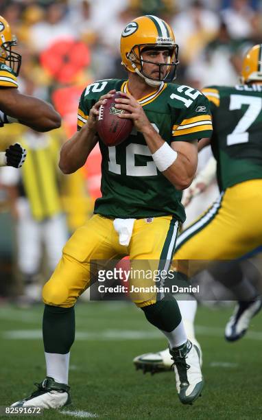 Aaron Rodgers of the Green Bay Packers drops back to pass on his only play of the game, a touchdown pass to Greg Jennings, in the 1st quarter against...